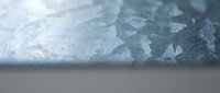 Close-up of cracked ice surface with detailed texture and crystalline formations showing natural winter patterns and frozen water structures.
