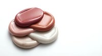Cosmetic foundation makeup smears in nude pink tones isolated on white background for beauty and skincare product advertising campaigns.