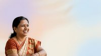 Young South Asian woman wearing traditional red and gold saree with bindi, smiling against soft pastel sky background, suitable for cultural diversity, traditional fashion, and lifestyle content.