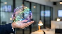 Businessman holding glowing network sphere with colorful connections in modern office environment representing digital transformation and connectivity.