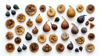 Dried figs, walnuts and dates arranged on white background. Organic nuts and dried fruits for healthy snacking, cooking and baking projects.