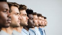 Diverse group of professional men in business attire standing in profile line formation representing teamwork, leadership and corporate unity in modern workplace.