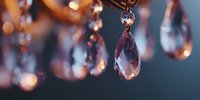Elegant crystal chandelier with sparkling glass drops creating warm ambient lighting for luxury interior design and home decor projects.