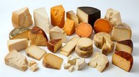 Assorted gourmet cheese collection featuring various textures and flavors from soft brie to aged cheddar perfect for charcuterie boards and culinary presentations.