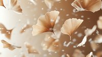 Delicate ginkgo biloba leaves in soft beige tones floating gracefully against blurred background with bokeh light effects, creating dreamy natural composition.