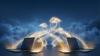 Laptops connected by glowing golden data streams to luminous clouds against a dark blue sky with city silhouettes, symbolizing cloud computing.
