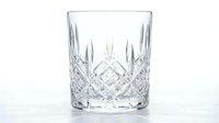 Crystal cut glass tumbler with diamond pattern isolated on white background for elegant dining and beverage service.