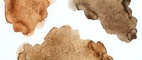 Abstract brown watercolor stains and splashes on white background for artistic design projects and creative compositions.