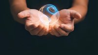 Male hands holding glowing orb with blue energy swirl, isolated against dark background. Concept for innovation, technology, power, future vision, and business solutions.