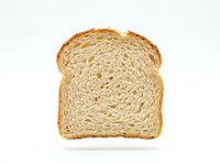 Sliced whole wheat bread isolated on white background, ready for food and bakery design projects, packaging, and culinary content.