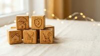 Wooden blocks with insurance icons including house, shield, yen currency and shopping cart symbols arranged on white surface with warm bokeh lights.