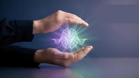 Businessman holding glowing brain hologram between hands, representing artificial intelligence, innovation, and digital technology concepts for business solutions.