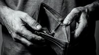 Elderly hands holding empty worn leather wallet showing financial hardship and poverty in dramatic black and white photography for social awareness campaigns.