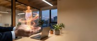 Businessman hand holding holographic human figure projection in modern office workspace for healthcare technology and digital innovation concepts.