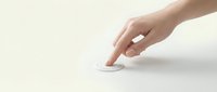 Hand pressing white button on neutral background, suitable for technology, interface design, user interaction, and web application concepts.