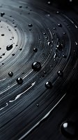Water droplets on black vinyl record surface creating glossy contrast with circular grooves, suitable for music or audio industry backgrounds.