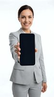 Young professional woman with dark hair and olive complexion wearing light gray business suit displaying blank smartphone screen toward camera with friendly smile on white background.
