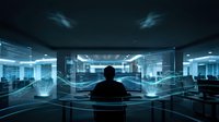 Businessman silhouette working with futuristic holographic interface displays in modern office environment for technology and innovation concepts.