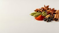 Aromatic spices and herbs collection with star anise, cardamom, cinnamon, paprika and black pepper on neutral background for culinary designs.