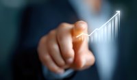 Business professional pointing at glowing upward trending graph chart showing growth and success, demonstrating positive financial performance analysis.
