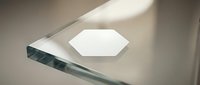 Modern minimalist glass award trophy with geometric hexagonal design on clean white surface showcasing corporate recognition and achievement excellence.