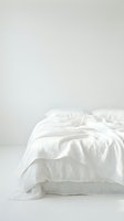 Unmade bed with white crumpled sheets and pillow on neutral background, isolated for interior design, bedroom decor, and lifestyle content use.