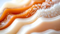 Abstract macro photograph of agate crystal with orange and white wavy layers showing natural mineral formation patterns and textures.