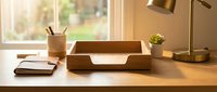 Minimalist wooden desk organizer tray with compartments on modern workspace setup. Natural wood office accessories for home or corporate environment organization.