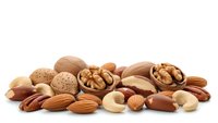Mixed nuts and seeds collection including almonds, walnuts, cashews, hazelnuts and pecans isolated on white background for healthy snacking and cooking.