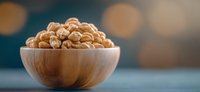 Roasted walnuts in wooden bowl on blurred bokeh background, healthy organic snack for vegetarian nutrition and natural food photography.