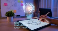 Business innovation concept with glowing lightbulb hologram and gears over notebook as entrepreneur writes startup ideas in modern office workspace.