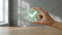 Hand holding glowing green checklist document icon with checkmark, symbolizing approval, task completion, and verified agreement in business.