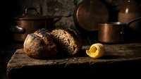 Whole coconuts with cracked shell and golden oil on rustic wooden surface, vintage copper cookware background, culinary and food styling use.