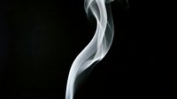 Elegant white smoke curl rising gracefully against a dark black background, capturing fluid motion and abstract texture for creative design projects.
