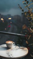 Cappuccino with latte art on marble table against evening cityscape with bokeh lights and decorative plants, moody atmospheric composition for cafe ambiance.