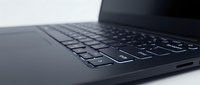 Close-up of black laptop keyboard with shallow depth of field, isolated on white background, ready for technology and business design projects.
