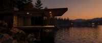 Modern lakeside cabin with illuminated interior at dusk, featuring contemporary architecture, large windows, and wooden deck overlooking calm water with forested mountains in golden hour lighting.