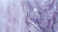 Purple marble texture with flowing veins and crystalline patterns creates elegant abstract background for luxury design projects and decorative applications.