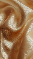 Luxurious golden brown leather texture with soft folds and grain pattern creating elegant waves and highlights, suitable for fashion and luxury product backgrounds.
