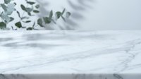 Marble tabletop with eucalyptus leaves and shadows, ideal for product display, cosmetics, wellness, and lifestyle branding backgrounds.