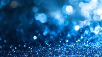 Sparkling blue glitter background with defocused bokeh lights creating magical atmosphere. Abstract festive backdrop with shimmering particles.