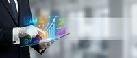 Businessman using digital tablet with holographic financial charts and data analytics visualization for business growth and market analysis in modern office.