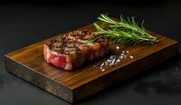 Juicy grilled beef steak with rosemary and sea salt on wooden cutting board against dark background, perfect for food menu presentation.