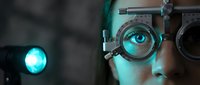 Close-up of person wearing steampunk goggles with glowing cyan lens, illuminated by bright turquoise light source, suitable for sci-fi and futuristic design projects.