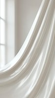 Flowing white fabric with soft folds and elegant curves against neutral background, suitable for luxury, fashion, textile, and design projects.