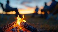 Glowing campfire with burning logs at sunset, silhouettes of people gathering around in background creating cozy outdoor atmosphere for camping and adventure stories.