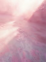 Ethereal pink and purple misty cloudscape with soft sunbeams breaking through dreamy atmospheric fog, creating mystical abstract background for spiritual designs.