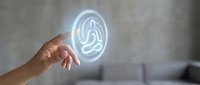 Hand touching glowing meditation pose hologram in modern interior space for wellness technology and mindfulness applications.
