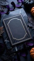 Dark gothic book with ornate frame surrounded by autumn leaves, purple ribbons and pumpkins on slate surface for Halloween themed designs and seasonal projects.