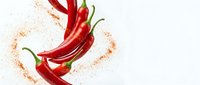 Fresh red chili peppers arranged in a dynamic swirl with scattered spice powder on a white background, perfect for food and culinary projects.
